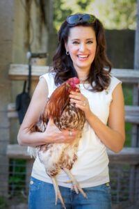 <p>Suzana Gartner, Animal Rights Activist, with a chicken at a sanctuary farm</p>
